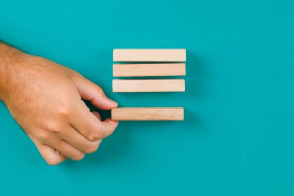 Person Adding a Block, Symbolizing The Logic Behind of a Marketing Email Structure